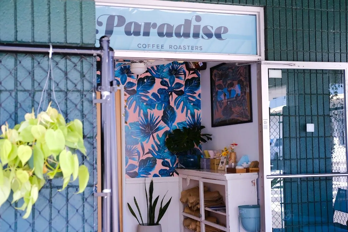 The signed entrance and blue interior wall at Paradise Coffee Roasters in Hilo