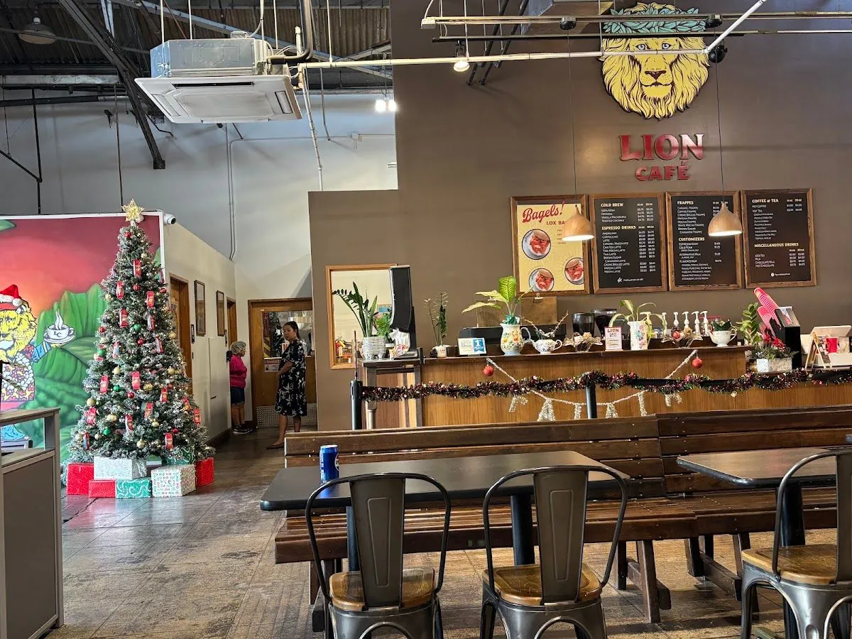 Tables, chairs, and the signed café counter at Lion Coffee in Kalihi