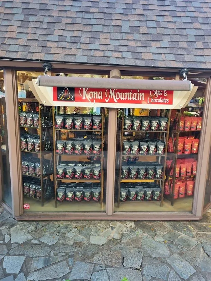 Kona Mountain Coffee's Waikiki shop window with its sign and bags of coffee